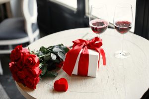 Gourmet Gift Baskets Review (2026): The Best Wine Gifts for Every Occasion? A romantic table setting with red roses, gift box, and red wine glasses, perfect for Valentine's Day celebration.