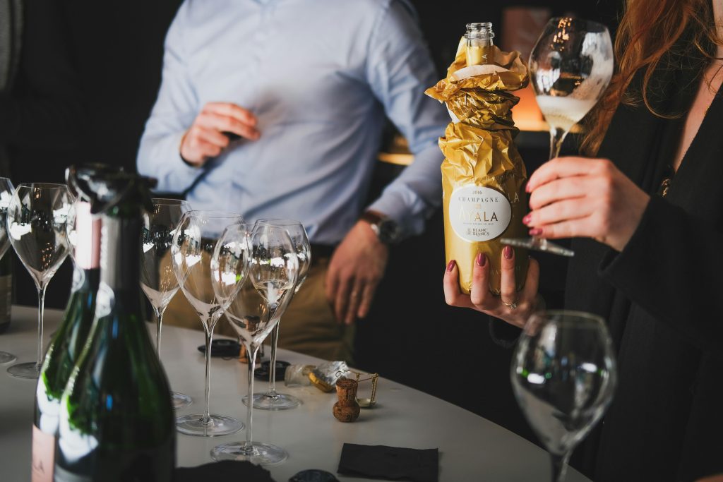 A refined gathering with people enjoying a champagne tasting in Aÿ-Champagne, France.