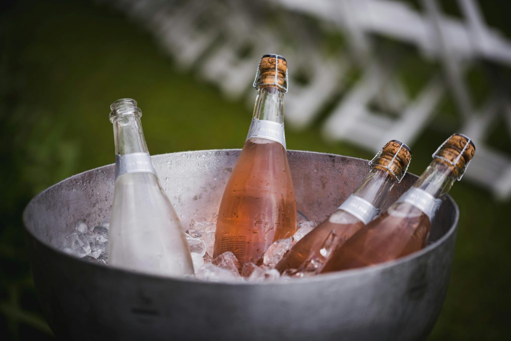 How to Pair Wine With BBQ: 5 Simple Rules Four champagne bottles chilling in an ice bucket, perfect for celebrations or events.