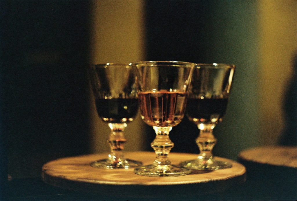 Three elegant wine glasses filled with red and pink wine creating a warm and inviting ambiance.