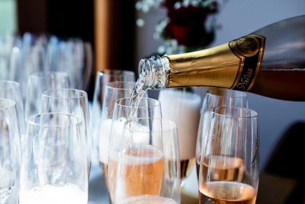 Elegant champagne being poured into flute glasses at a celebration or event.