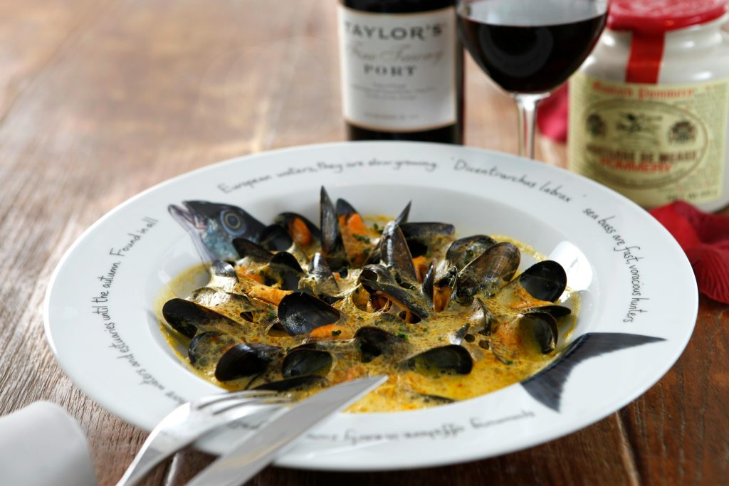 Close-up of a mussel dish with wine, capturing the essence of fine dining.