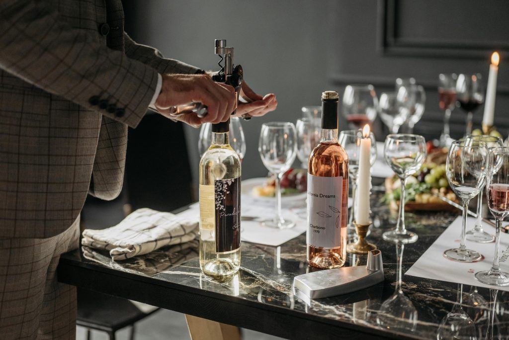 An elegant table setting with wine bottles and glasses ready for a tasting event.