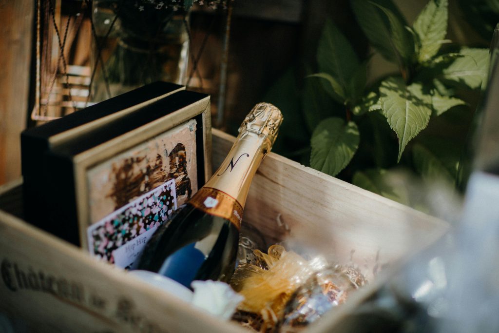 Best Wine Gifts for Father's Day (USA&UK) Elegant close-up of champagne bottle in a stylish wooden gift box with decorative elements.