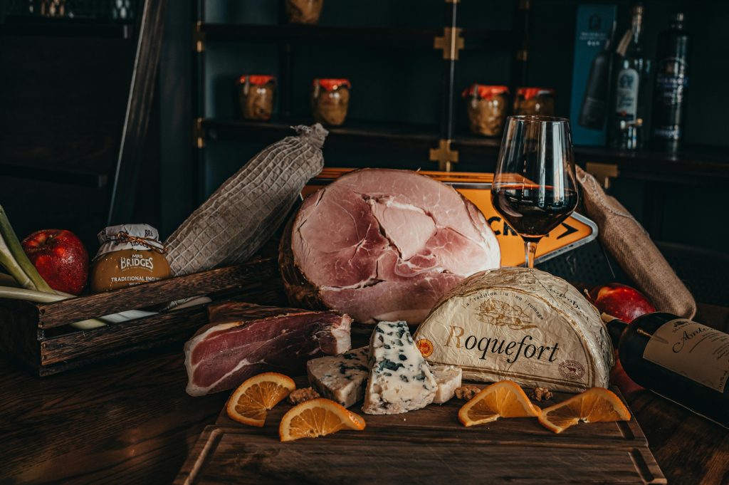 Wine and Ham Pairing: What Actually Works Savor a gourmet cheese and charcuterie platter with wine in an elegant indoor setting.