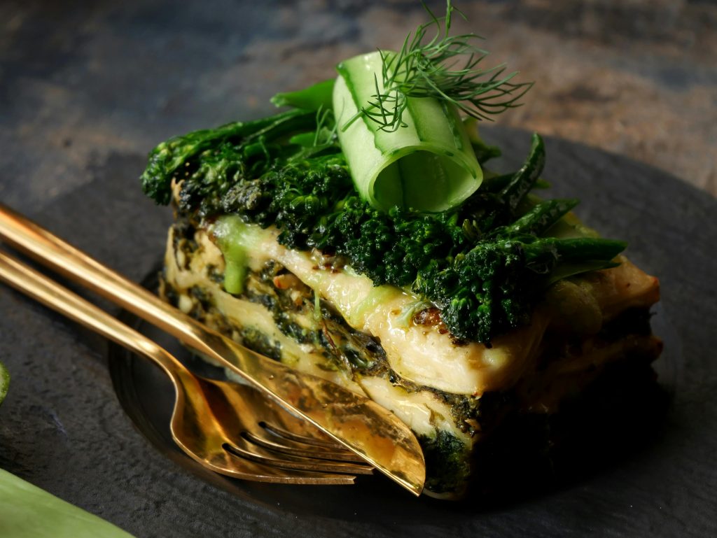 Delicious vegetarian lasagna topped with fresh greens, perfect for a healthy meal.