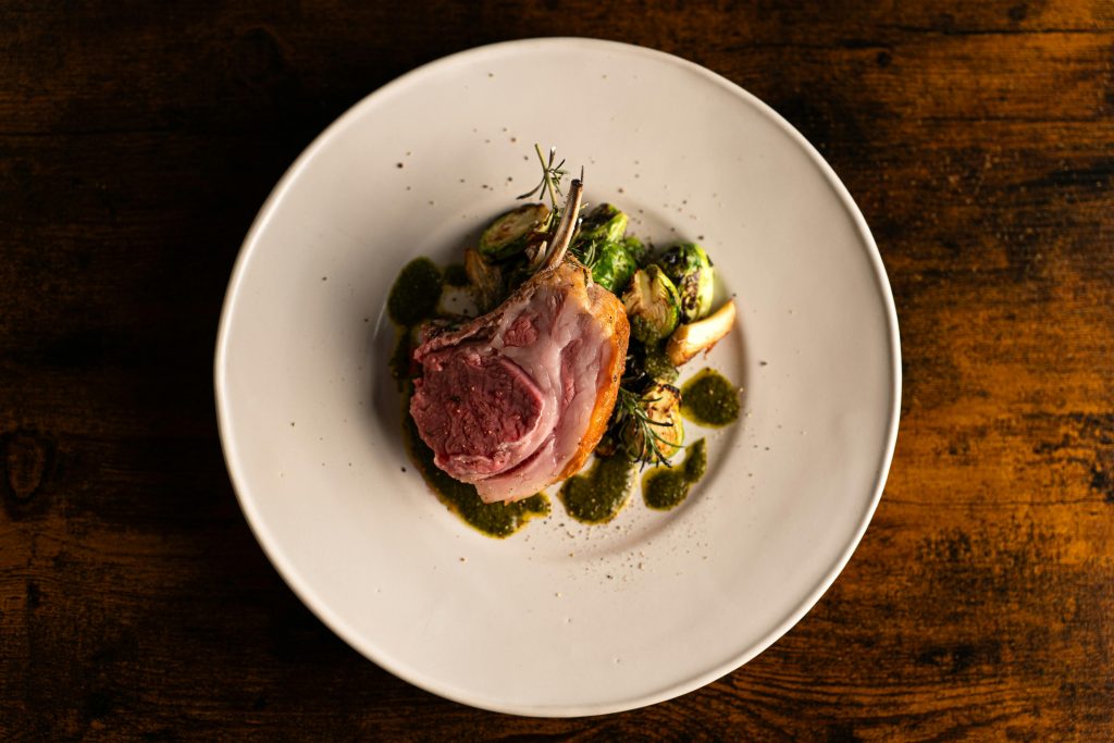 Wine and Lamb Pairing: The Definitive Guide Exquisite plated lamb dish with brussels sprouts and sauce in Tokyo's fine dining scene.