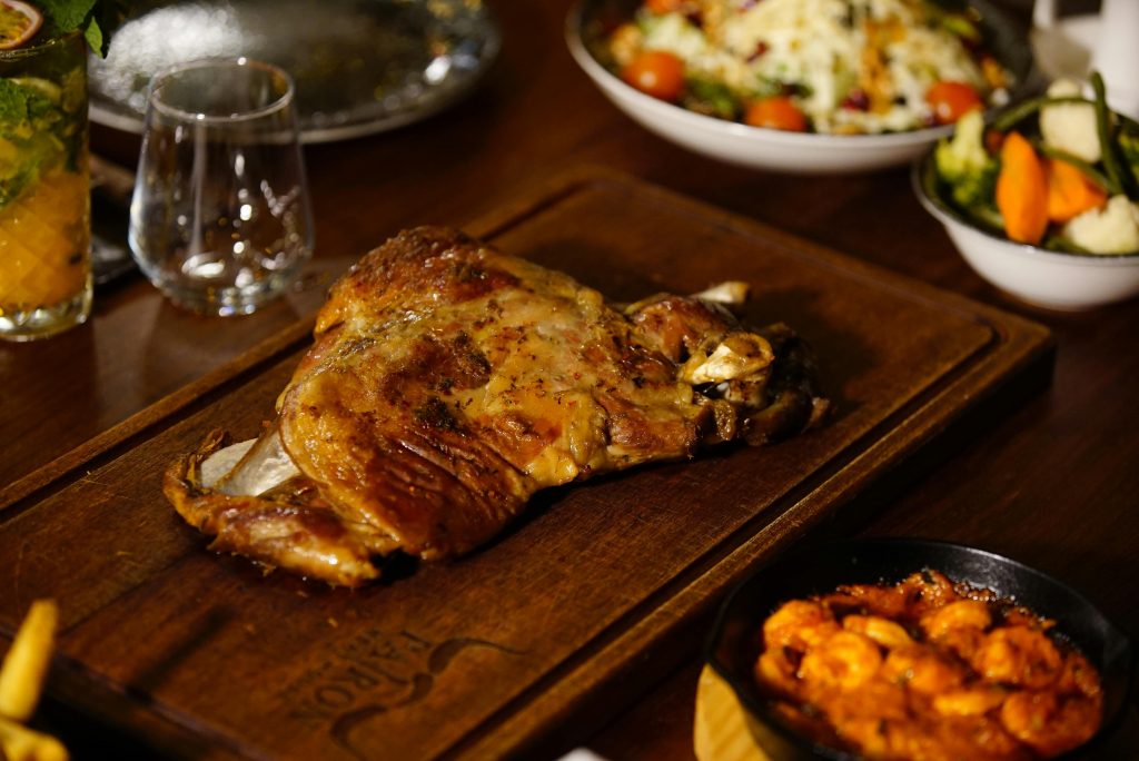 Wine and Lamb Pairing: The Definitive Guide A mouthwatering grilled lamb dish served with vegetables and sauces, perfect for a gourmet feast.