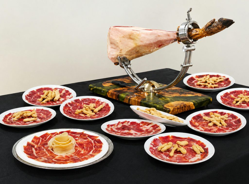 Wine and Ham Pairing: What Actually Works Elegant display of Spanish Serrano ham on plates with breadsticks, perfect for gourmet dining.
