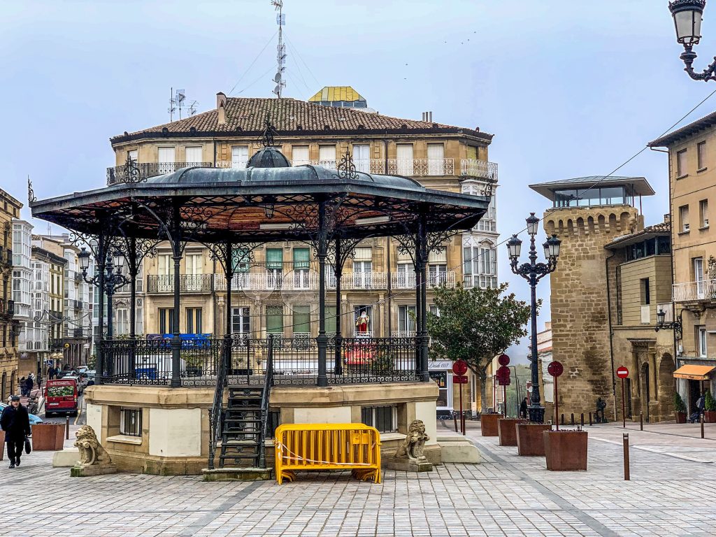 Beautiful town square with a classic gazebo, lampposts, and vibrant architecture.