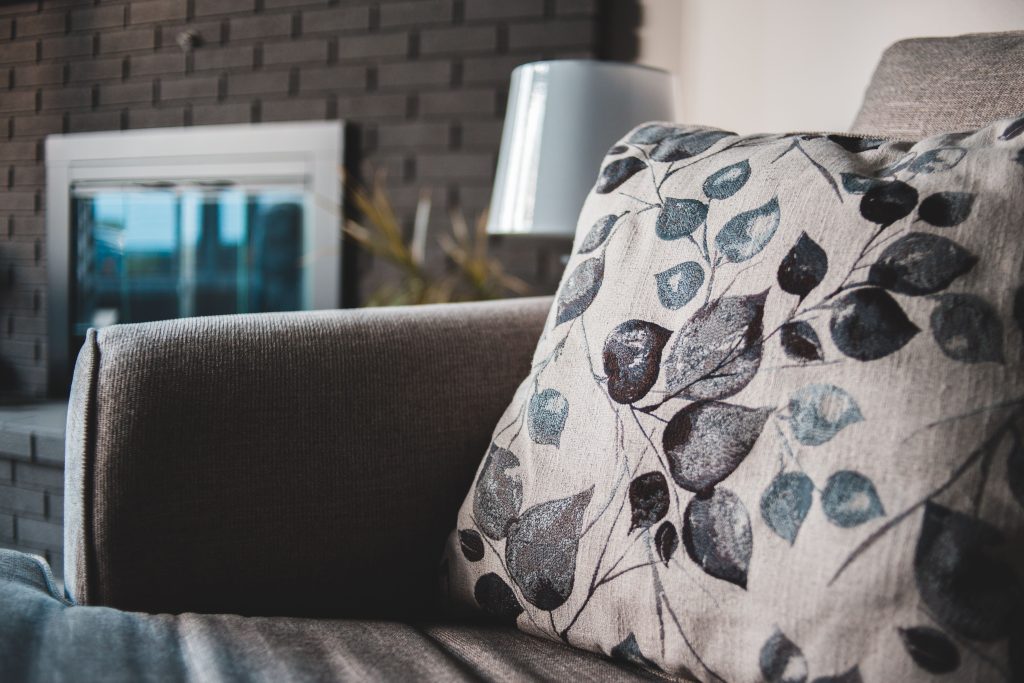 Modern interior scene featuring a leaf-patterned cushion on a stylish sofa.