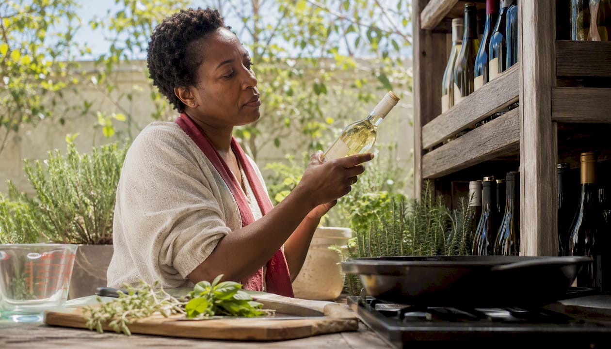 Woman choosing affordable white cooking wine bottle