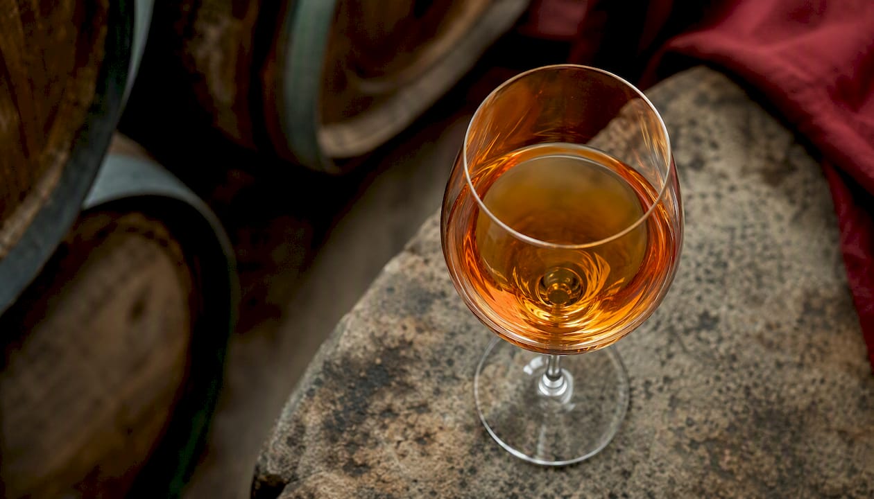 Glass of amber orange wine close-up