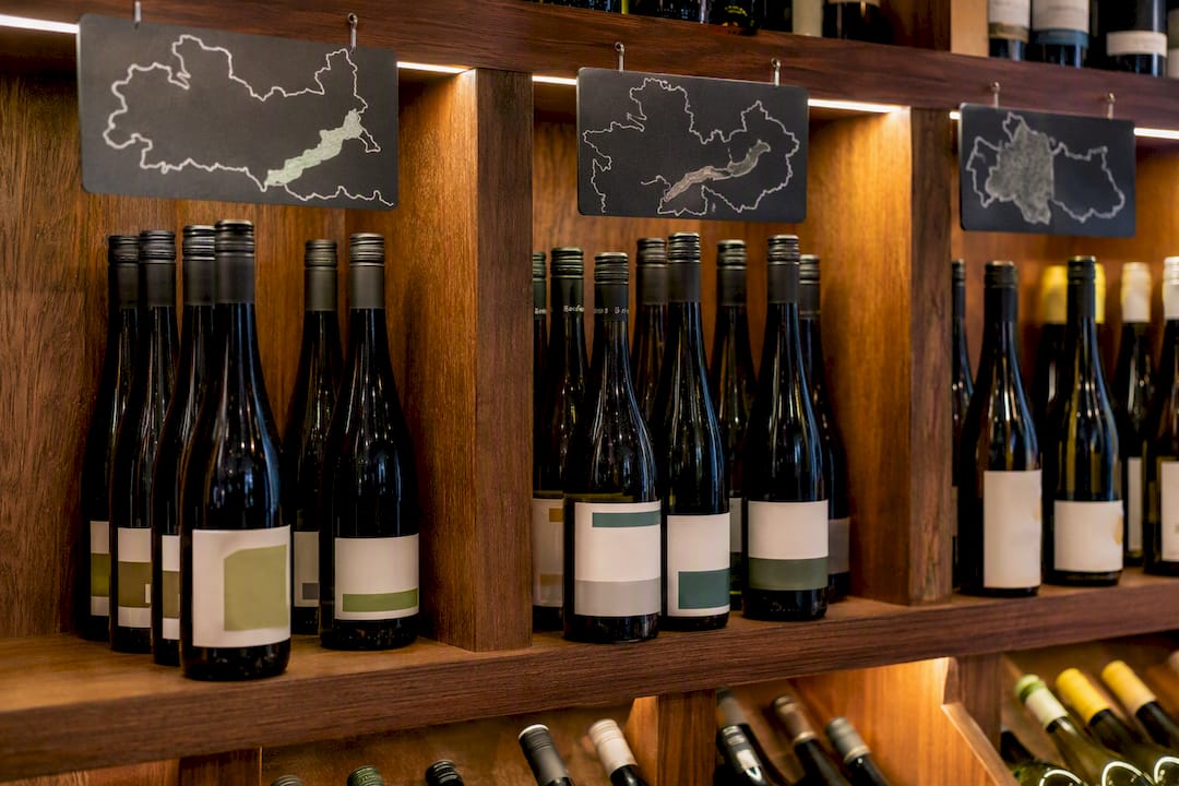 Grüner Veltliner: Austria's Peppery, Food-Friendly White Shelf of labeled Austrian Grüner Veltliner bottles