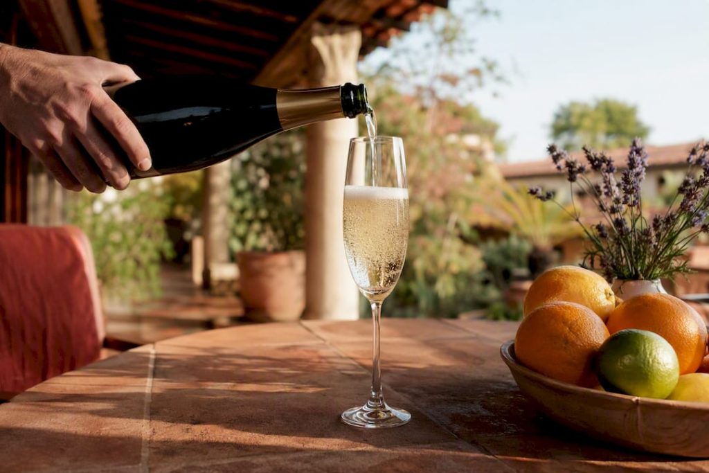 Pouring sparkling Champagne into glass