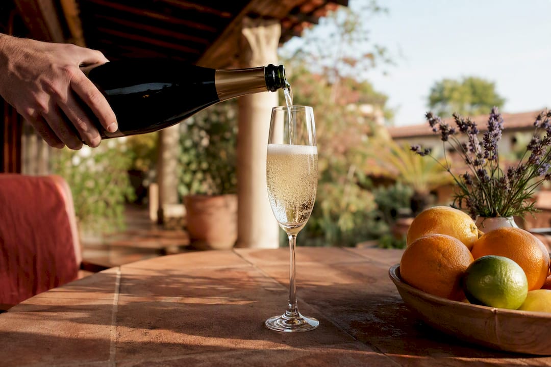 Pouring sparkling Champagne into glass